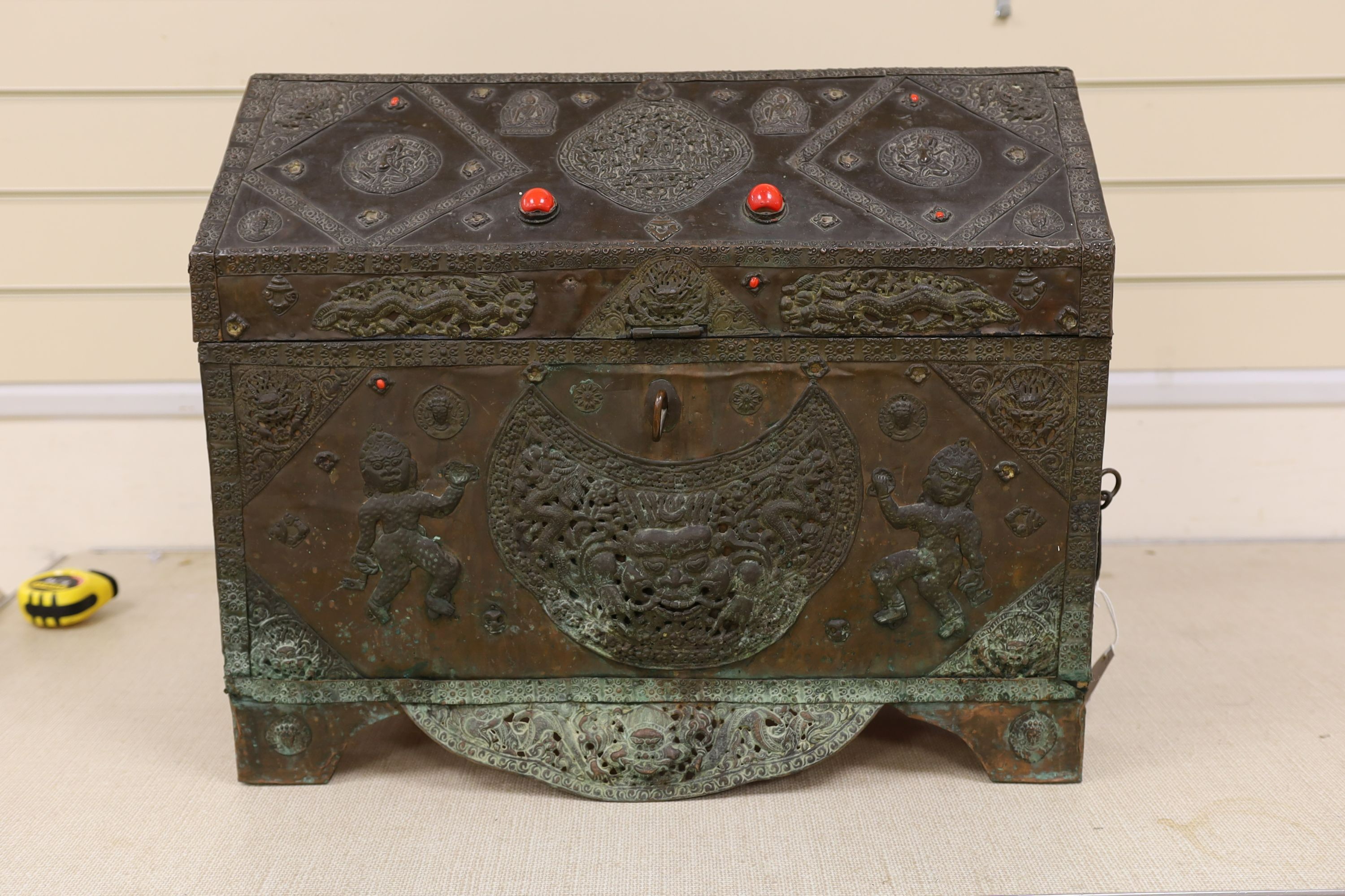 A Tibetan copper repousse-work casket, 20th century, 65cm wide, 49.5cm